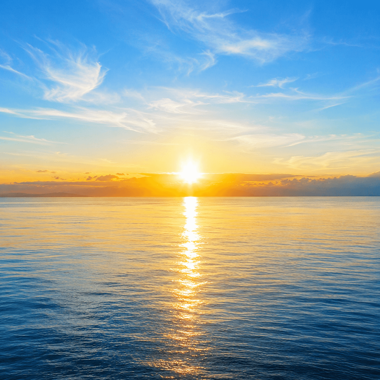 A radiant sunrise over a calm sea, the sun casting a path of golden light across the water