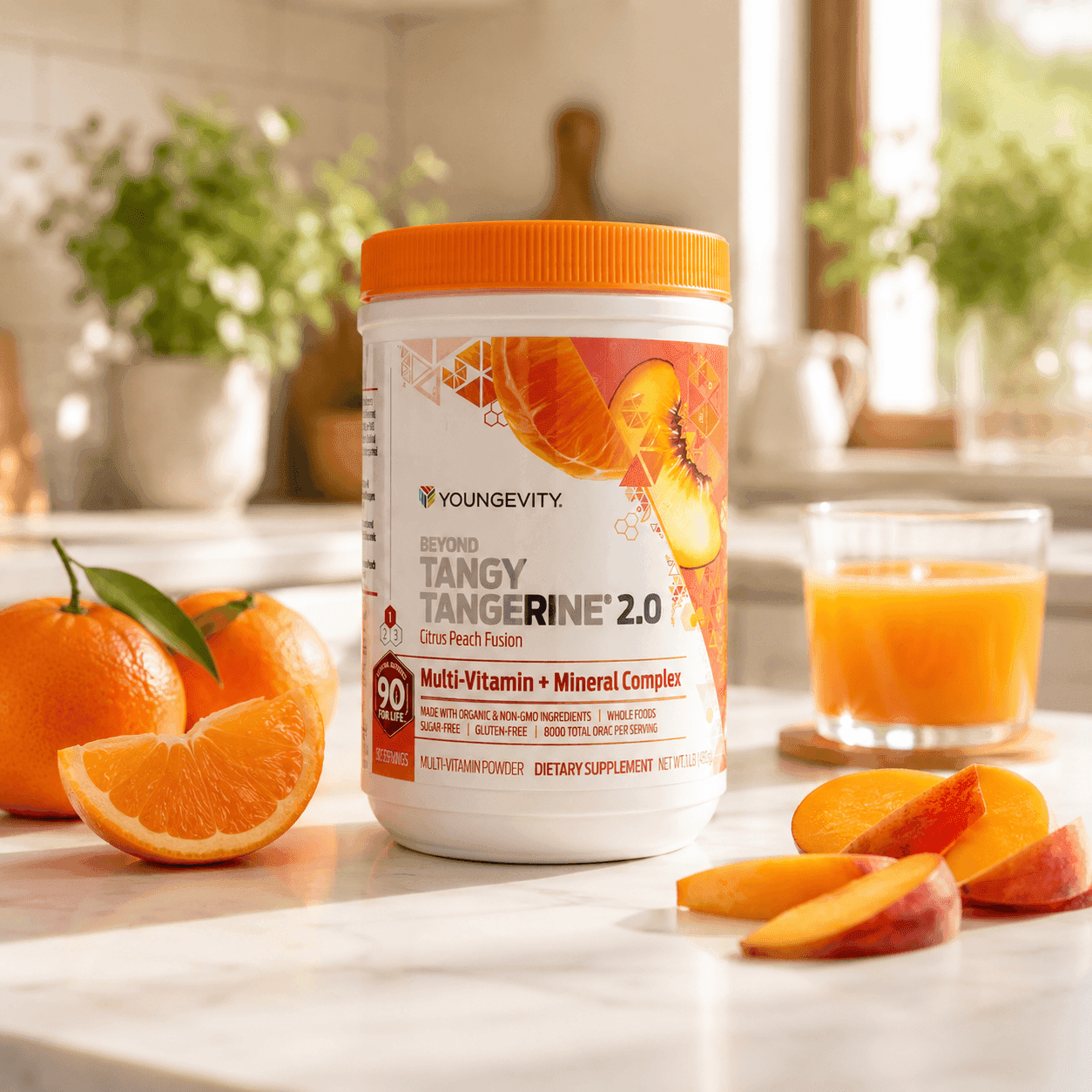 A container of Beyond Tangy Tangerine 2.0 multivitamin powder on a kitchen counter beside fresh oranges, peach slices, and a glass of orange juice